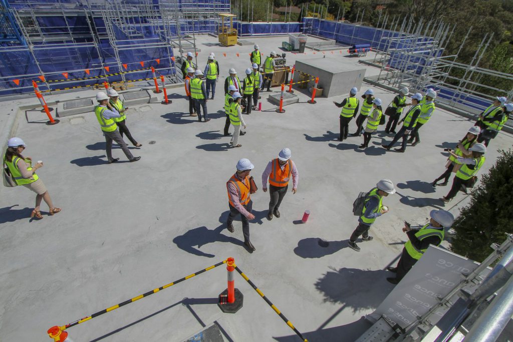 Construction team standing on top of a building