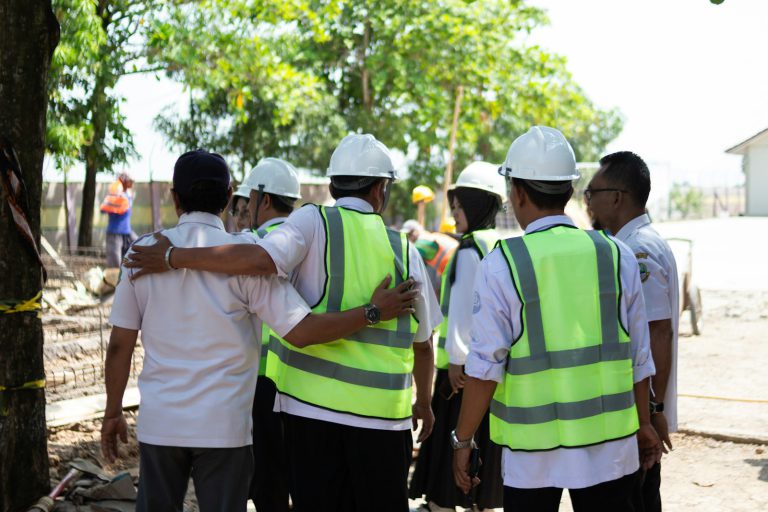 Construction workers huddled together