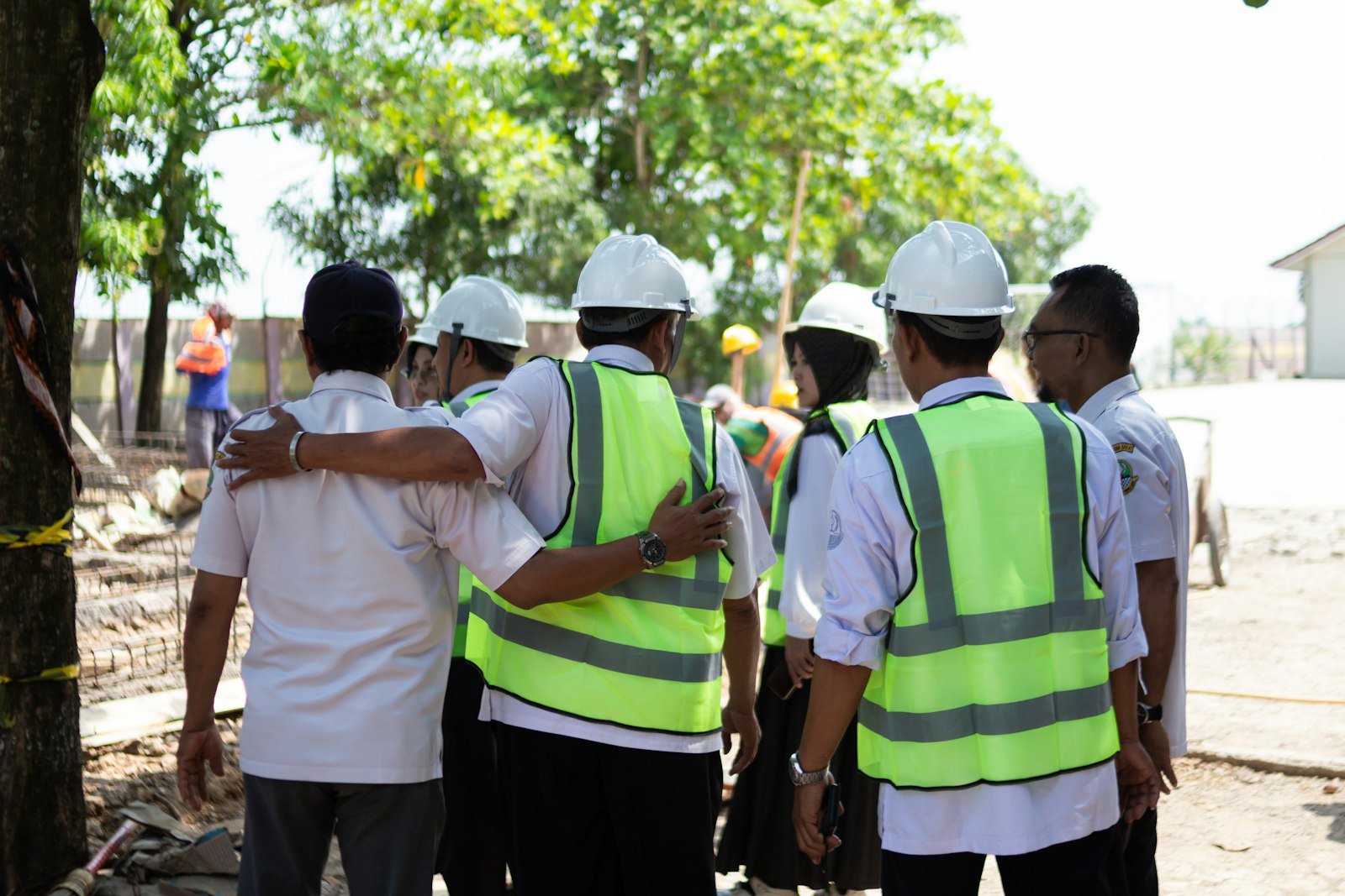 Construction workers huddled together