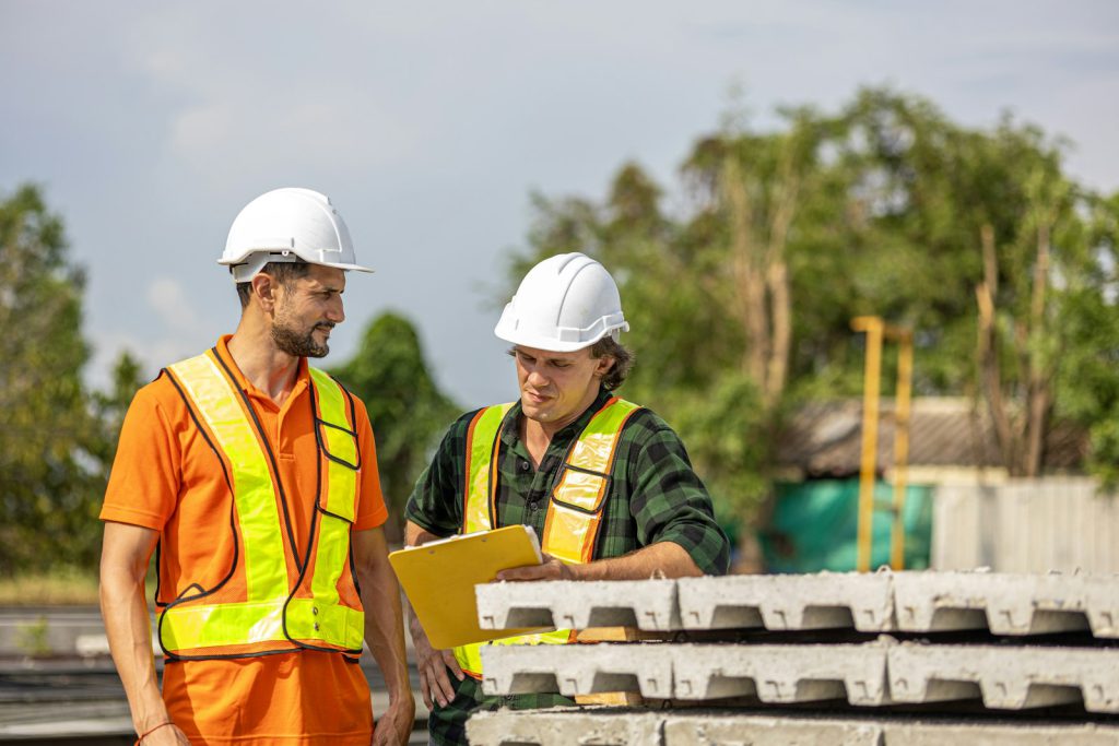 Construction workers reviewing plans on site