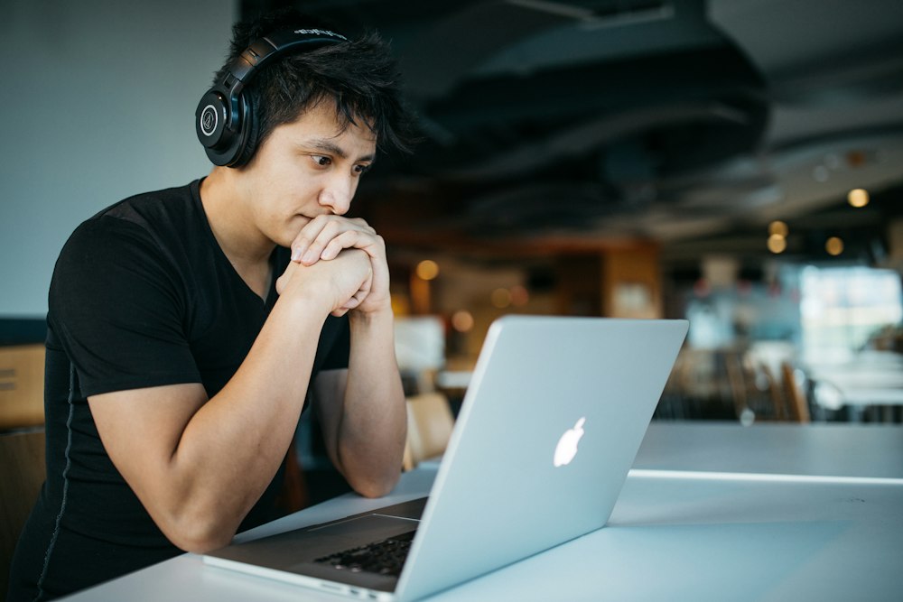 Employee with headphones at a laptop