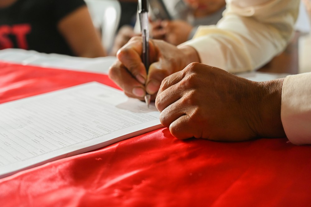 Person writing notes on a document