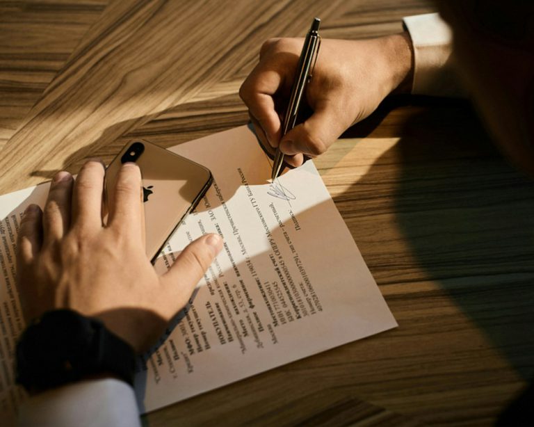 Person writing on paperwork