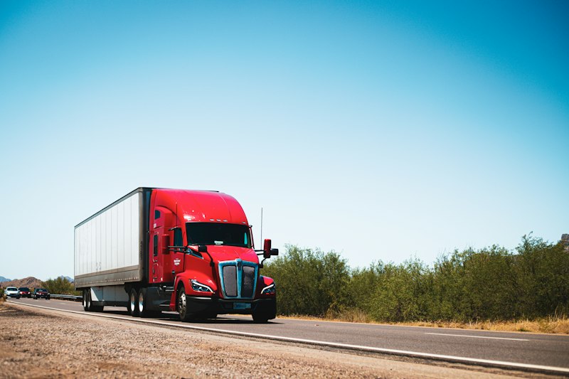 Red semi-truck on a country road