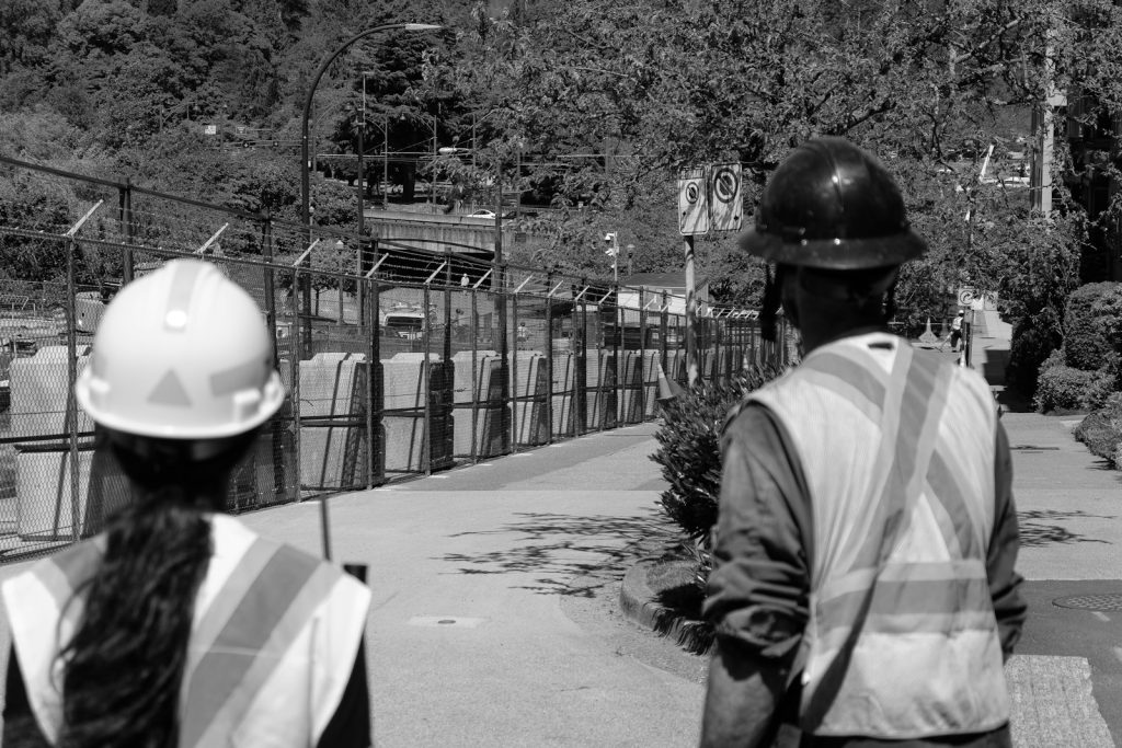 Two construction workers in hard hats and vests