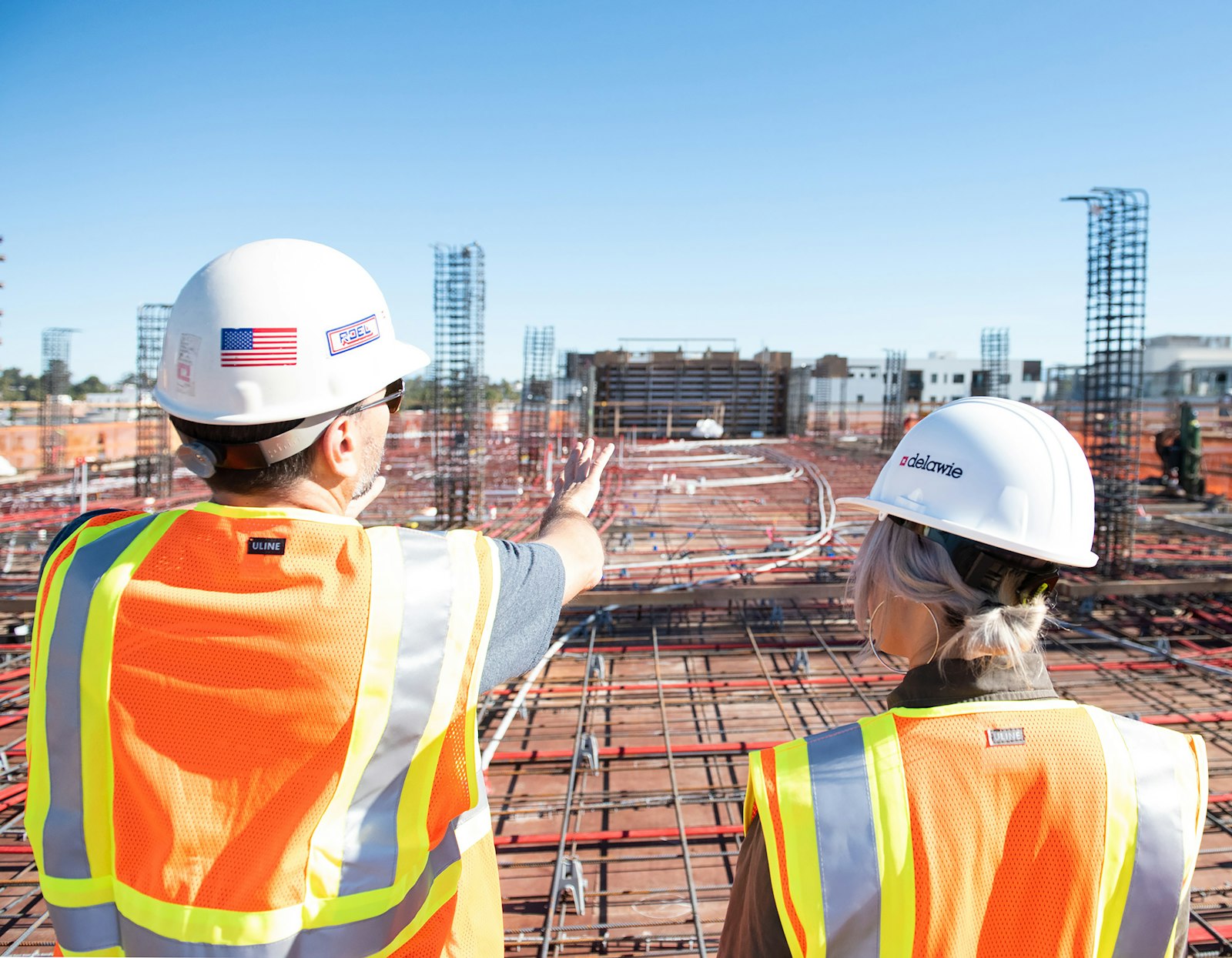 Two construction workers in safety vests on site