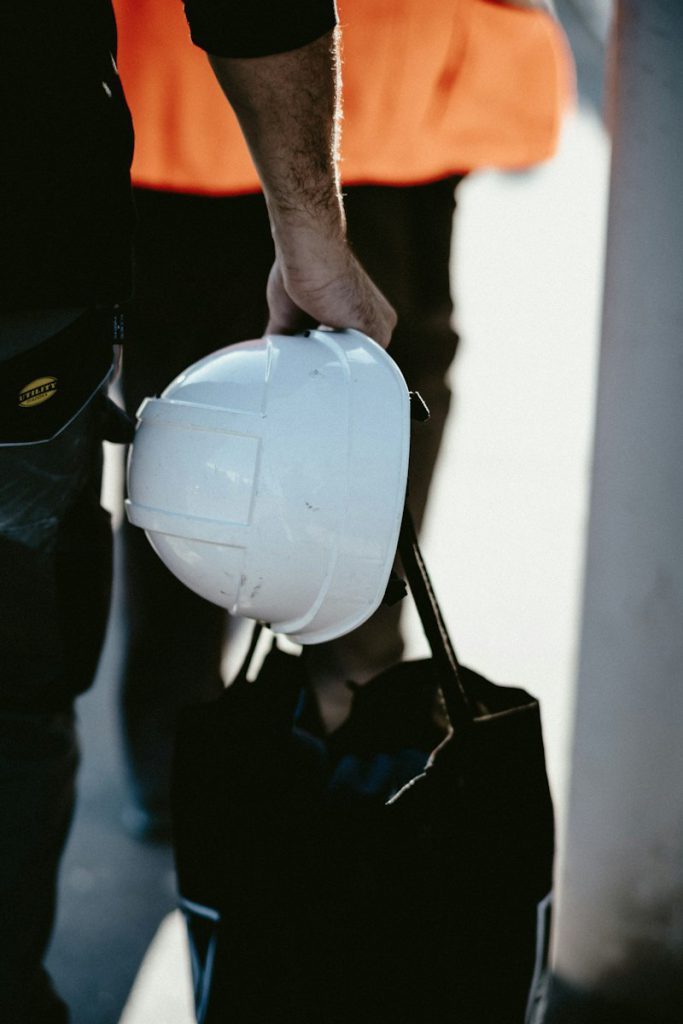 Worker holding a white hard hat