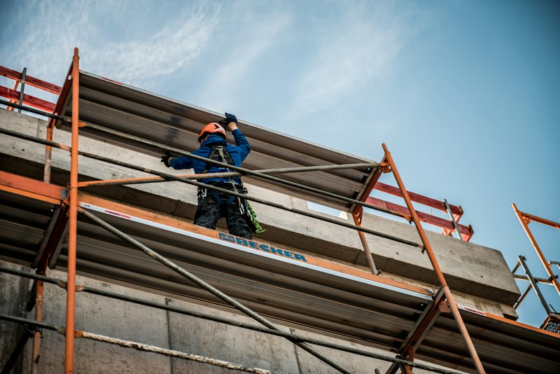 Worker on scaffolding working on a building