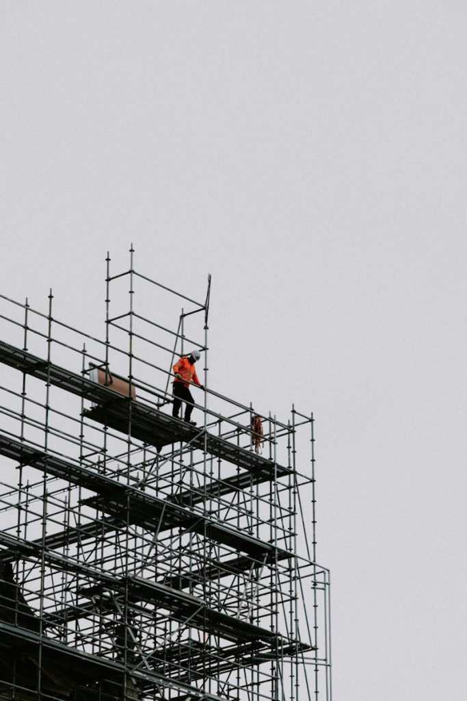 Worker standing on scaffolding on a building