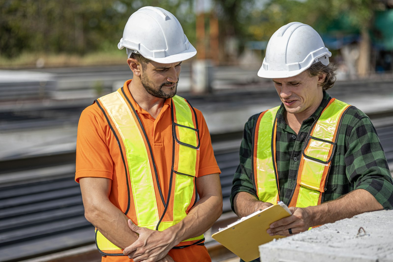 Construction workers reviewing plans at a job site